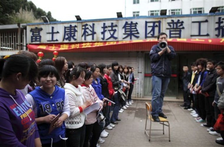 A recruiter talks to Foxconn job seekers Feb. 24 in Shenzhen, south China's Guangdong province. Many Chinese workers recently have seen their pay increased 20 percent or more.